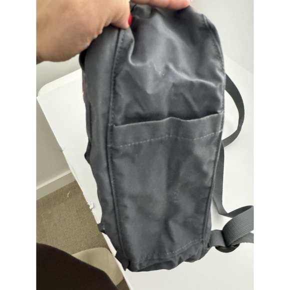 fjallraven mini grey backpack Kanken Fog sitting pad in the pocket in the back and logo that doubles as a reflector. Fjallraven - Kanken Mini Classic